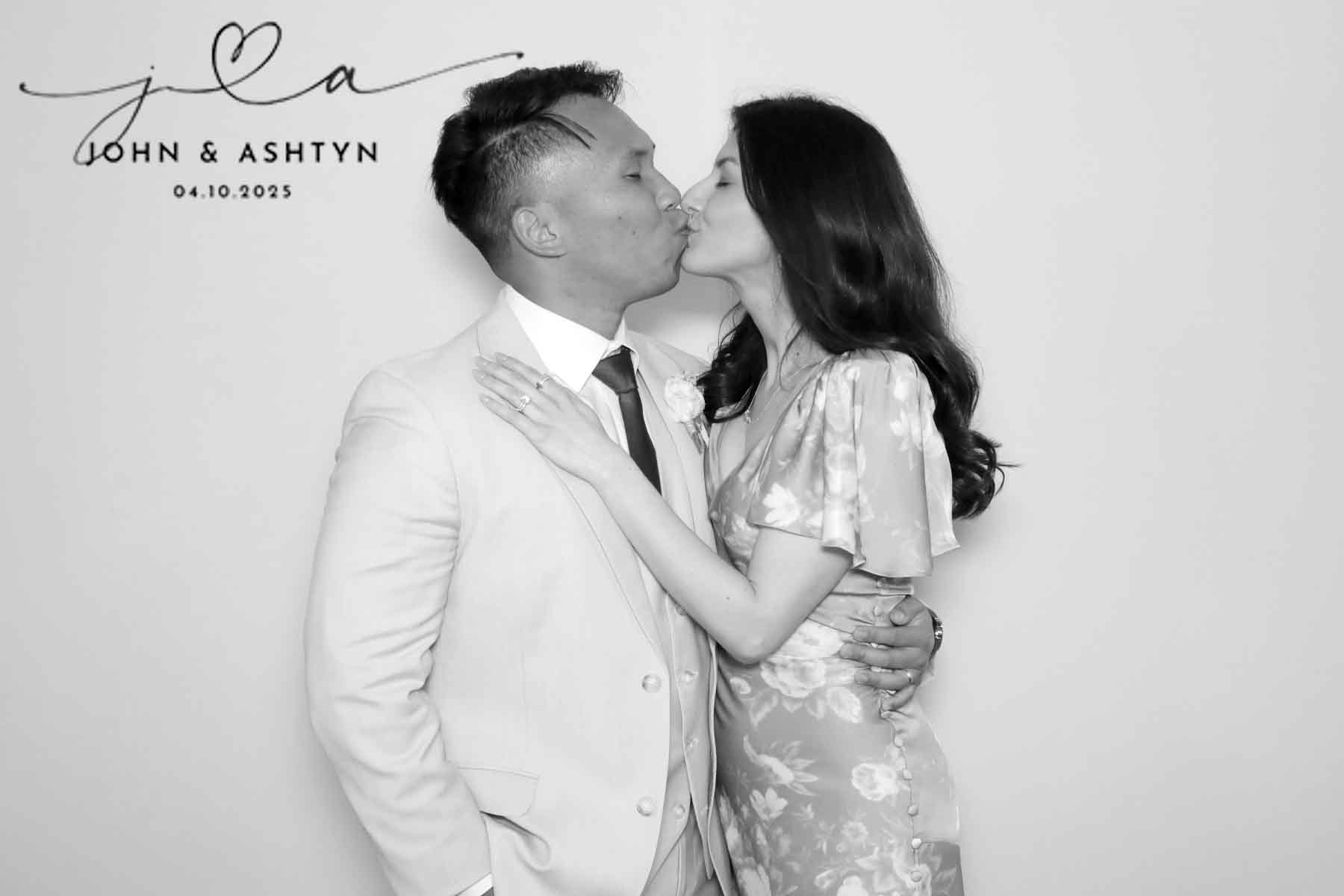 Couple kissing against a white backdrop